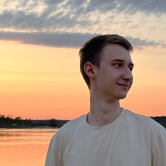 Danylo Klymov by the water at sunset
